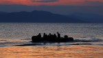 A dinghy with Syrian refugees is towed by a Greek coast guard patrol boat into port on Greek island of Kos, following a rescue operation, May 31,&nbsp;2015